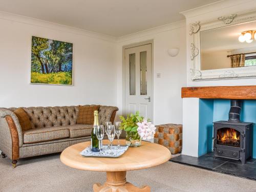 a living room with a couch and a wood stove at Evergreen House in Runswick