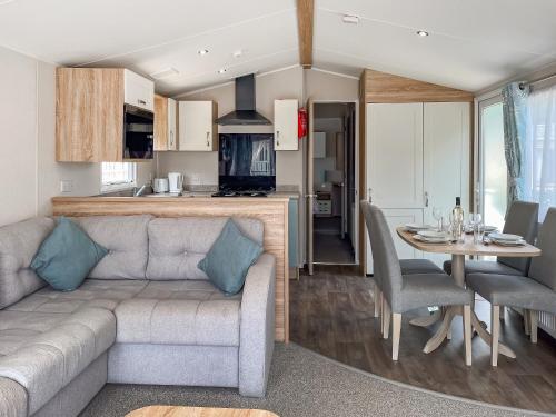 a living room and kitchen with a couch and a table at Whispering Pines Spa - Uk50087 in Durham