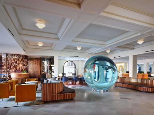 a lobby with a large blue orb in the middle at 21c Museum Hotel St Louis in Saint Louis