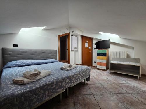 a bedroom with a bed with towels on it at Residence Hotel Azzurro in LʼAquila
