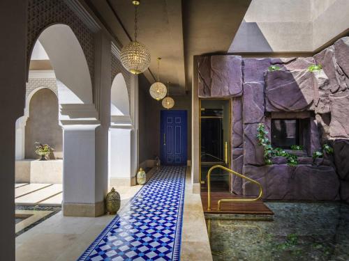 a hallway with a blue tile floor and a blue door at Rixos Premium Saadiyat Island - All Inclusive in Abu Dhabi