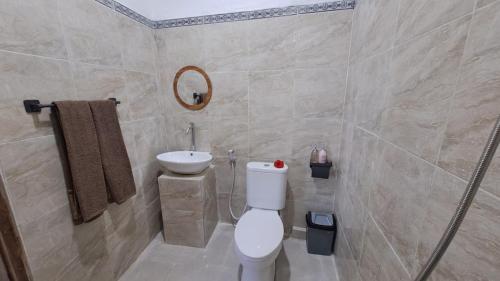a bathroom with a toilet and a sink at Double view point sibetan in Tenganan