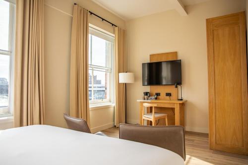 a hotel room with a bed and a window at School Lane Hotel in Liverpool ONE in Liverpool