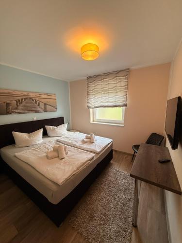 a bedroom with a bed with two towels on it at Villa Fleesenstrand in Göhren-Lebbin