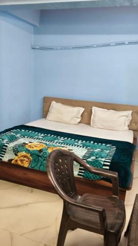 a bedroom with a bed and a chair and a chair at Hotel Diamond in Gwalior