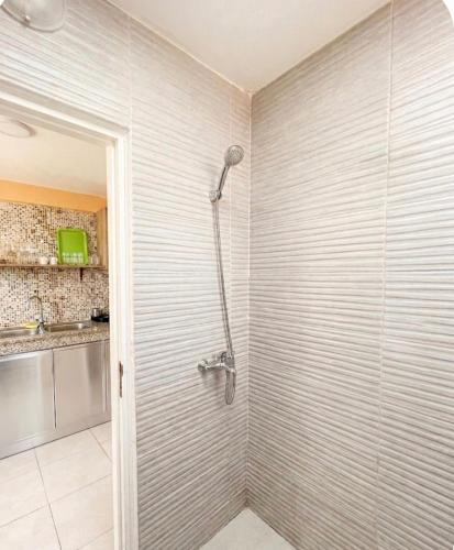 a shower stall in a bathroom with a shower at Small functional and impeccable loft facing the sea in Douar el Arbi Ben Ahmed