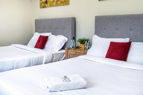 two beds with red and white pillows in a room at 800 Mountains view in Fujairah