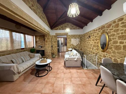 a living room with a couch and a table at Elaia's Seaside heaven in Elia Laconias