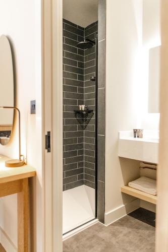 a bathroom with a shower and a sink at School Lane Hotel in Liverpool ONE in Liverpool
