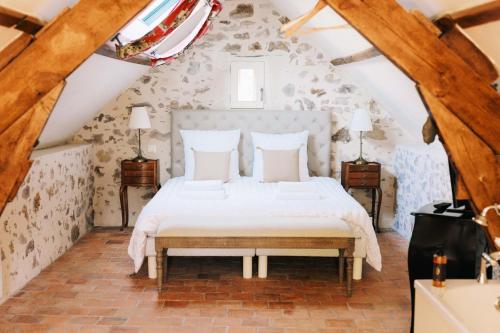 a bedroom with a bed in a attic at La Boire Bavard in Blaison