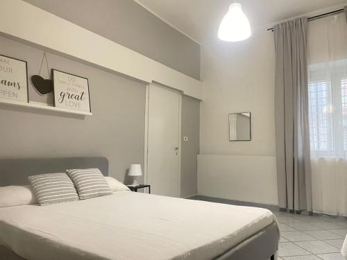 a bedroom with a large bed with white sheets at Casa vacanze Da Fra in Cariati