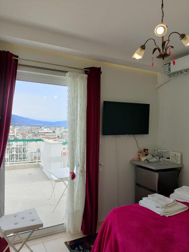 a bedroom with a bed and a window with a view at Heavenly joy in Patra