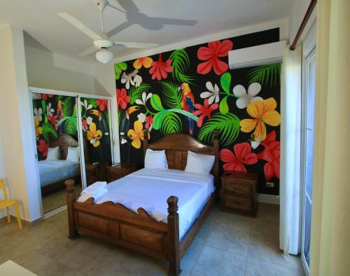 a bedroom with a mural of flowers on the wall at Bayahibe Premium Pool in Bayahibe