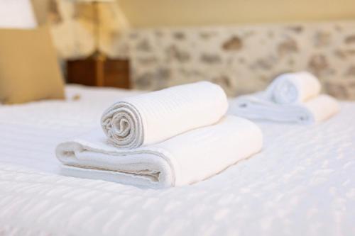 a pile of towels sitting on a bed at La Boire Bavard in Blaison