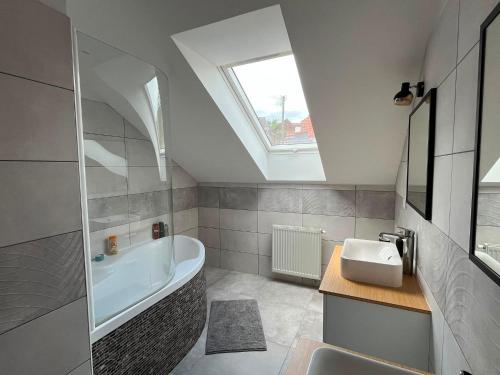 a bathroom with a sink and a bath tub at Apartmán U nás na vsi in Nový Jáchymov