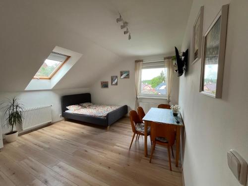 a room with a table and a bed and a dining room at Apartmán U nás na vsi in Nový Jáchymov