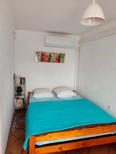 a bedroom with a bed with a blue bedspread at GRANDE PLAGE A 50 Métres in Valras-Plage