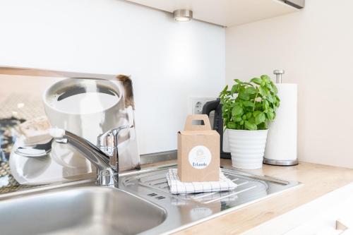 a kitchen sink with a paper bag on the counter at Südkap C-02 in Pelzerhaken