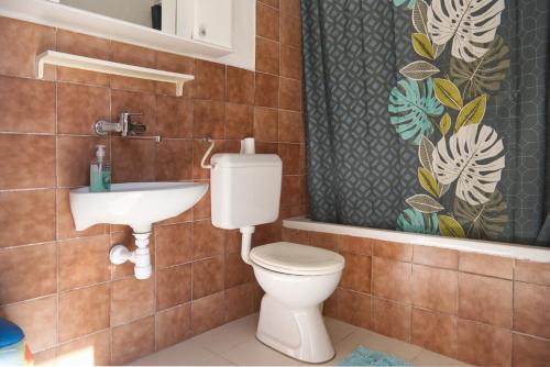 a bathroom with a toilet and a sink at Robinson Ilijana in Gdinj