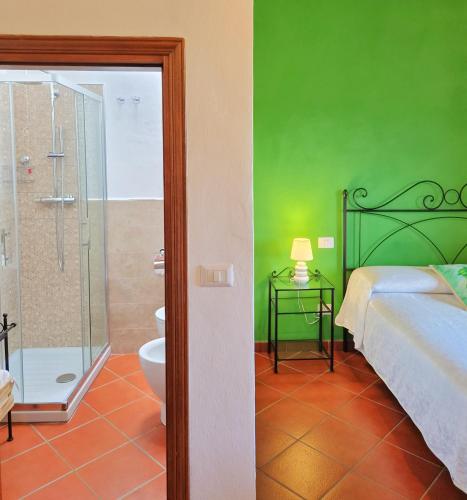 a bedroom with a bed and a shower and a toilet at Il casale di Sandra in Chiusi