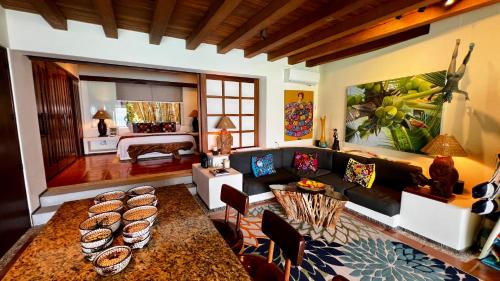 a living room with a couch and a table at 1 bdrm condo, Manzanillo Bay, Troncones in Troncones