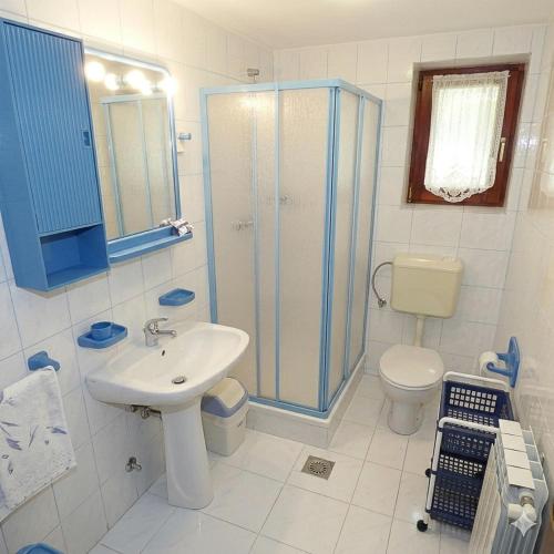 a bathroom with a sink and a shower and a toilet at Apartments Ruby in Funtana