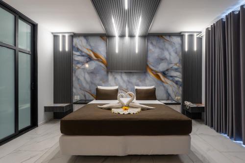 a bedroom with a bed with a flower on it at Hotel Elegance NV in Paramaribo
