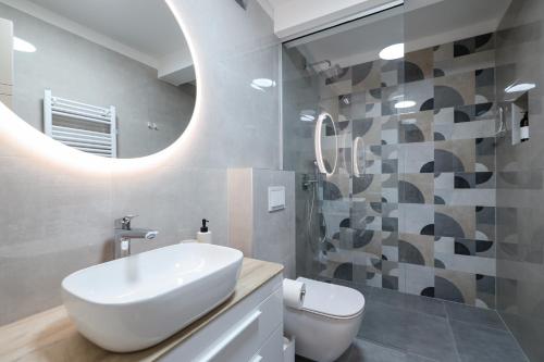 a bathroom with a white sink and a mirror at Rooms Sorićev Dvor in Preko