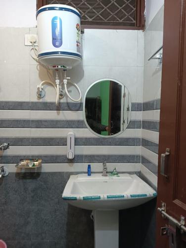 a bathroom with a sink and a large mirror at Trishool inn residency in Chandrāpuri