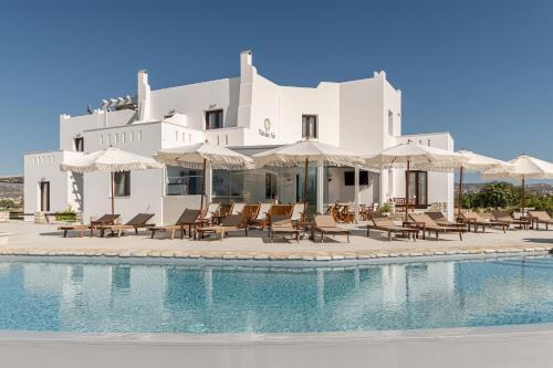 a villa with a swimming pool and chairs and umbrellas at Naxian Air in Naxos Chora