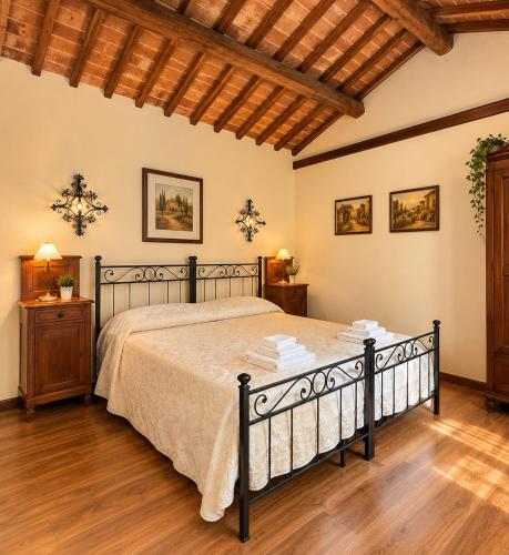 a bedroom with a bed and a wooden floor at La Busa alloggi e trattoria in Ponte San Nicolo