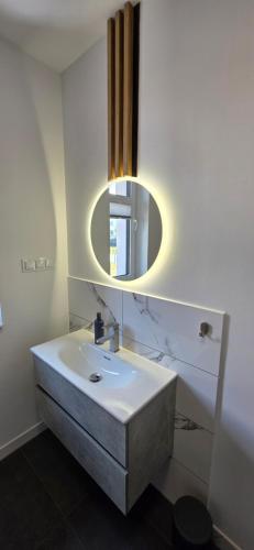 a bathroom with a sink and a mirror at Turystyczna 9 apartamenty & cafe in Sobótka