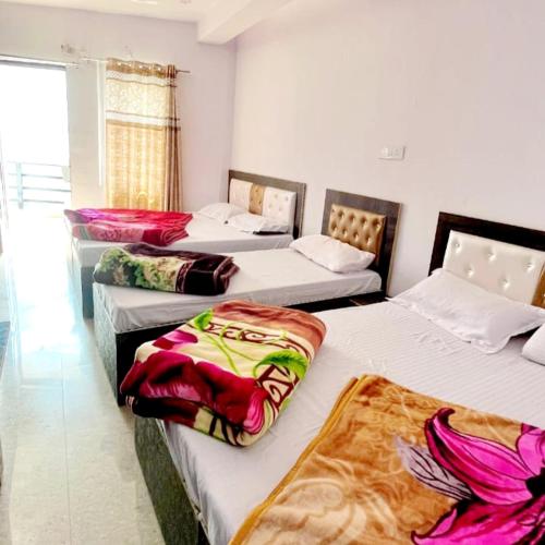 a room with three beds with blankets on them at Trishool inn residency in Chandrāpuri