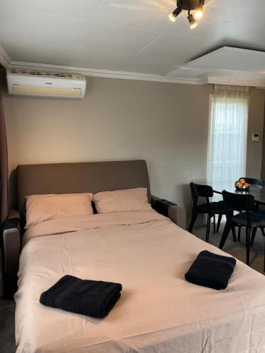 a bedroom with a large bed with two pillows on it at Villa Paradiso in Loosdrecht