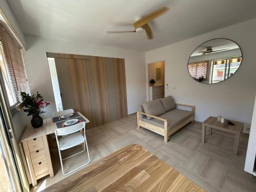 a living room with a couch and a mirror at Chez Raka in Hyères