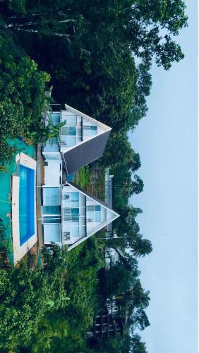 an aerial view of a building in the trees at Oxygen Rain Forest Resort in Kūmudi