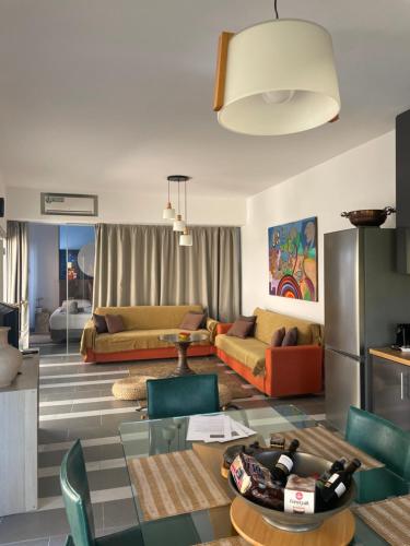 a living room with a couch and a table at Villa Elpiniki in Ixia
