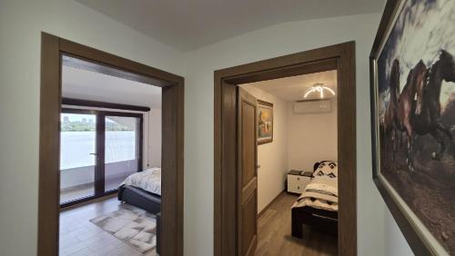 a bedroom with a bed and a door with a window at Belgrade River House in Belgrade