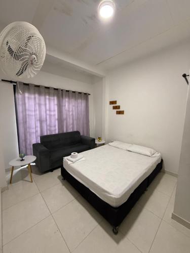 a bedroom with a bed and a couch in it at SANTYS HOUSE MELGAR apartamento amoblado 6 Huéspedes in Melgar