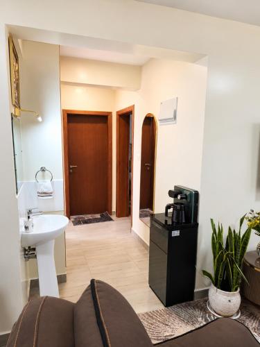 a living room with a couch and a sink at Savanna Living in Nakuru