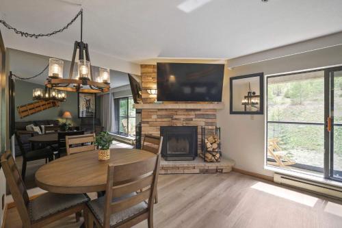 a living room with a table and a fireplace at Beaver Run Resort 4228 - Dog Friendly in Breckenridge