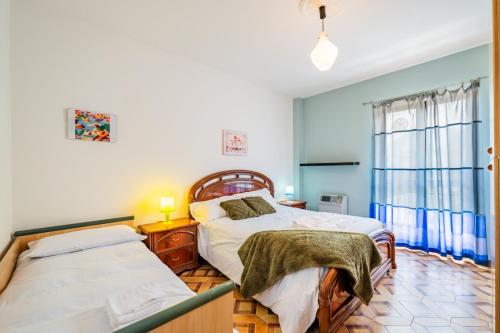 a bedroom with two beds and a window at All'antico Peso in Demonte