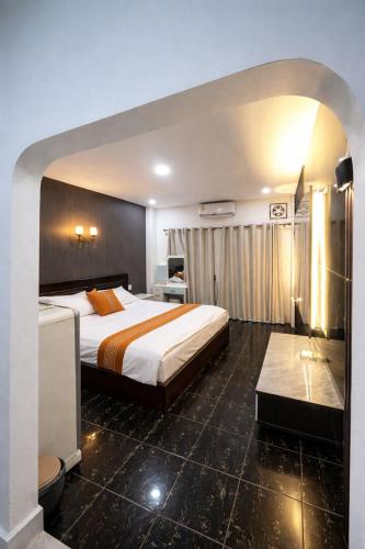 a hotel room with a large bed and a bathroom at YT Hotel & Hostel Vientiane in Vientiane