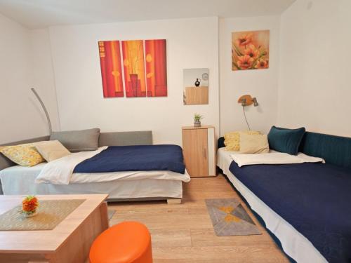a living room with two beds and a couch at Apartman Lola Ruža in Zrenjanin