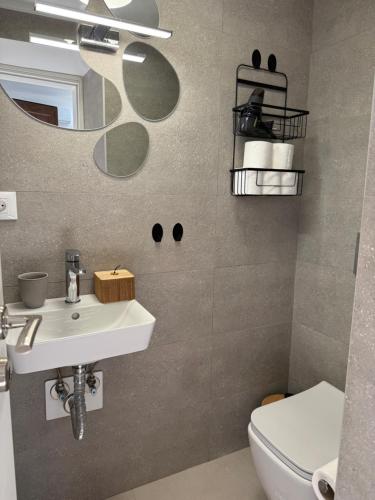 a bathroom with a sink and a toilet and a mirror at Kalithea Palekastro in Palekastron