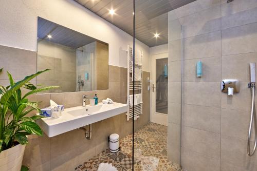 a bathroom with a sink and a shower at Gästehaus Angela in Garmisch-Partenkirchen