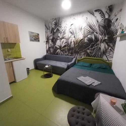 a room with a bed and a couch in it at Sky Apartments Petrovac in Petrovac na Moru