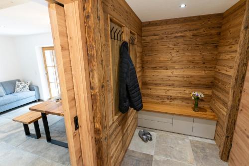 a sauna with a wooden wall in a room at Chalet Kogelleiten in Ramsau