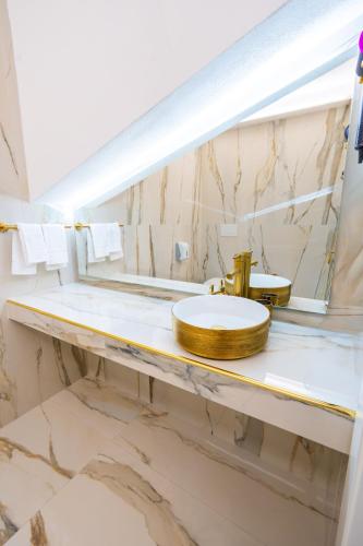 a bathroom with a sink and a mirror at Letoh Apartment in Catania