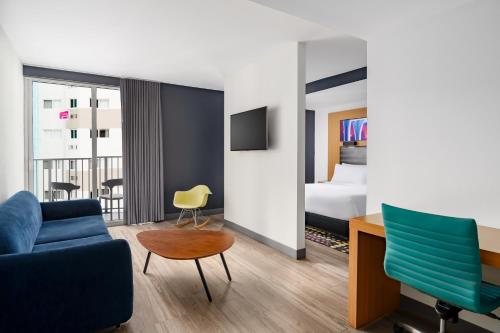 a hotel room with a couch and a bed at Aloft by Marriott Miami - Brickell in Miami